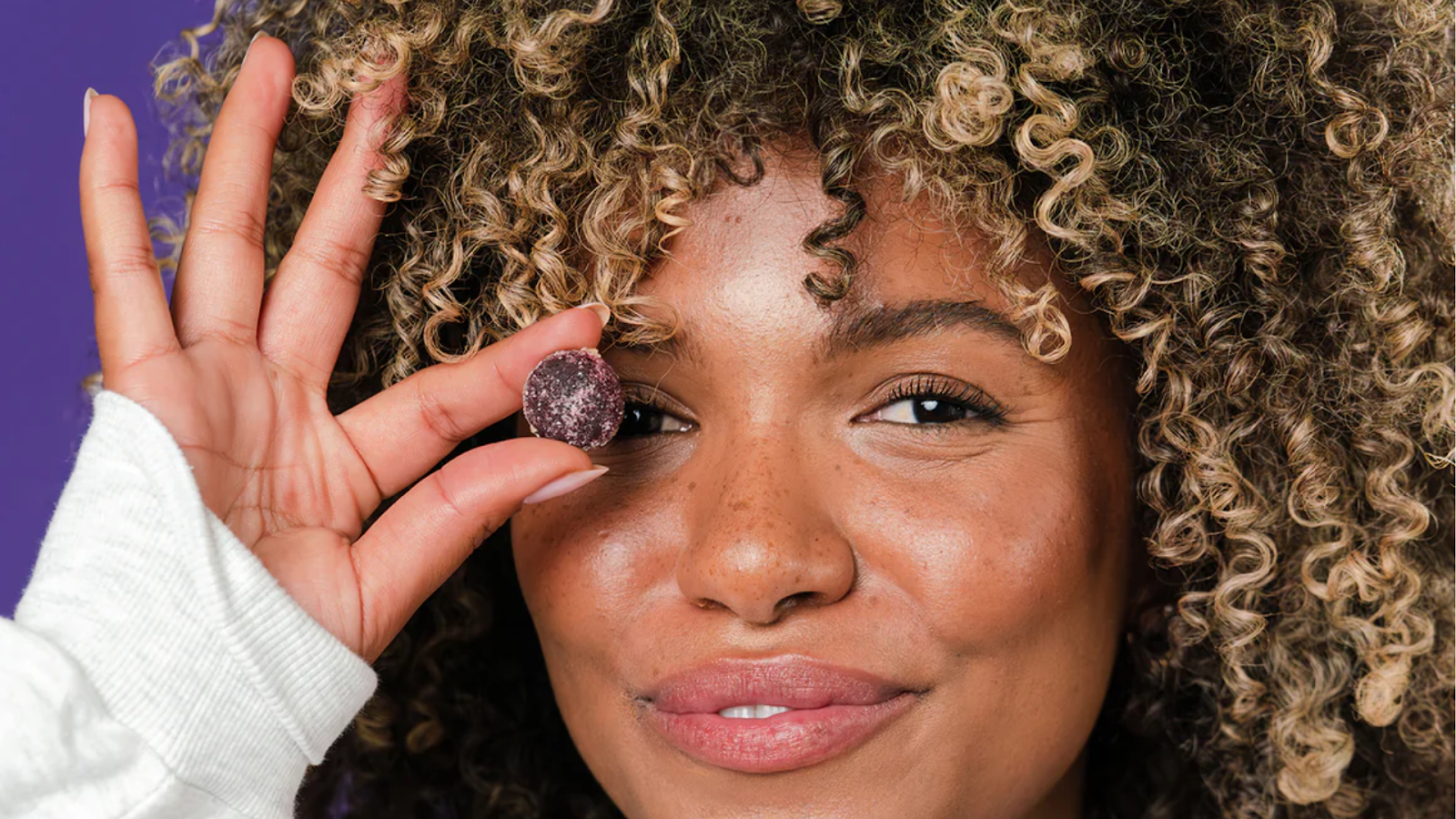 A Person Holding a CBD Dreams Gummy from Radiant Wellness.