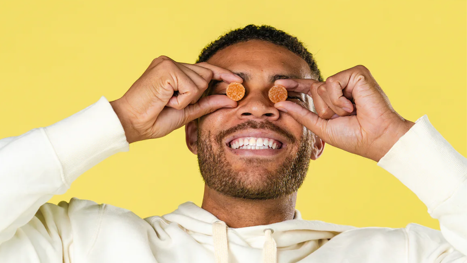 A Person Smiling With CBD Calming Gummies