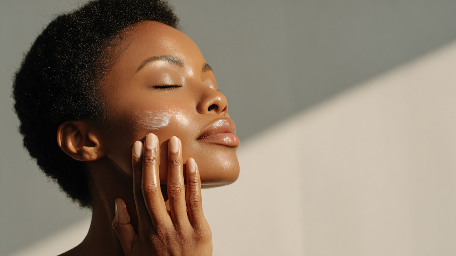 A woman applying a CBD skin care product.