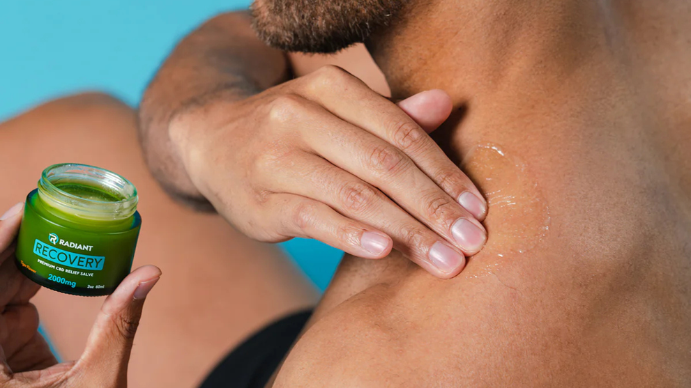 Applying Radiant Wellness’ Recovery Salve for faster pain relief.