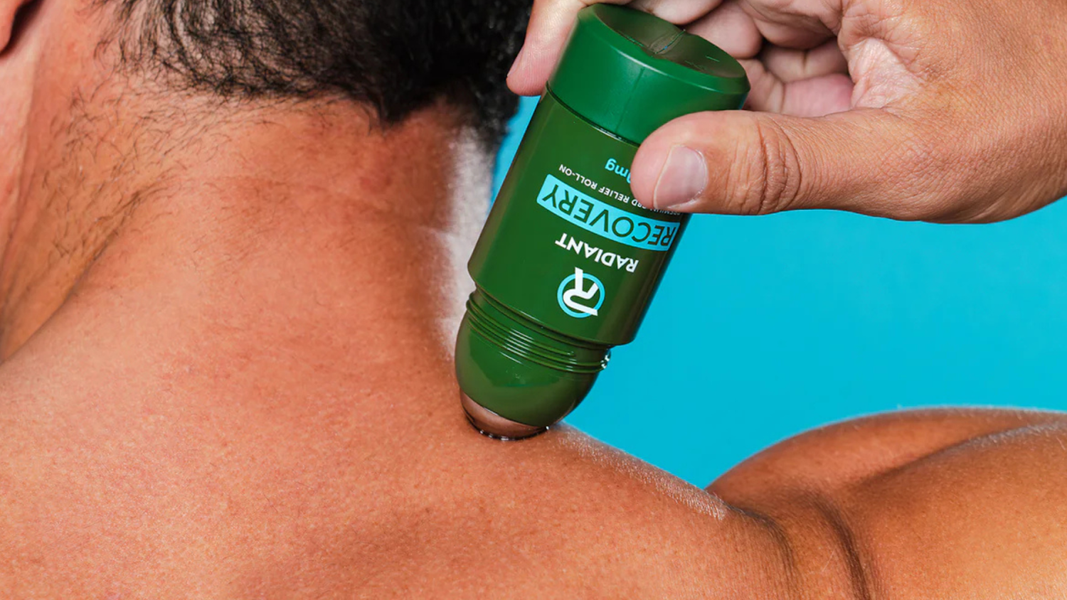 Applying Recovery Roll-On with CBD for back pain relief