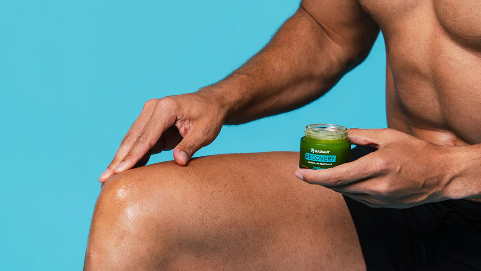 Man applying recovery salve on knee