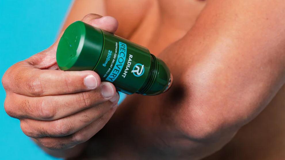 Person using Radiant Recovery CBD roll-on on their elbow